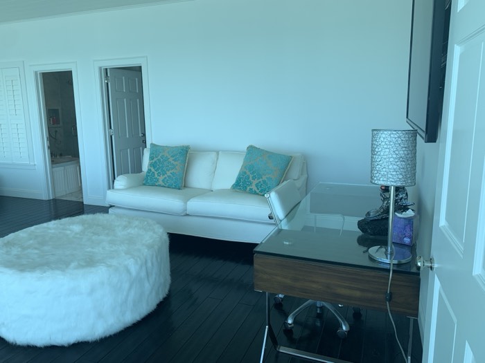 Spotless living room with white sofa and teal accent pillows
