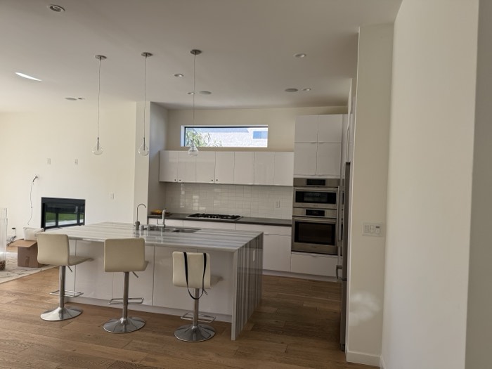 Clean white kitchen with island seating