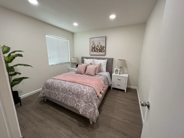 Staged bedroom with soft pink bedding